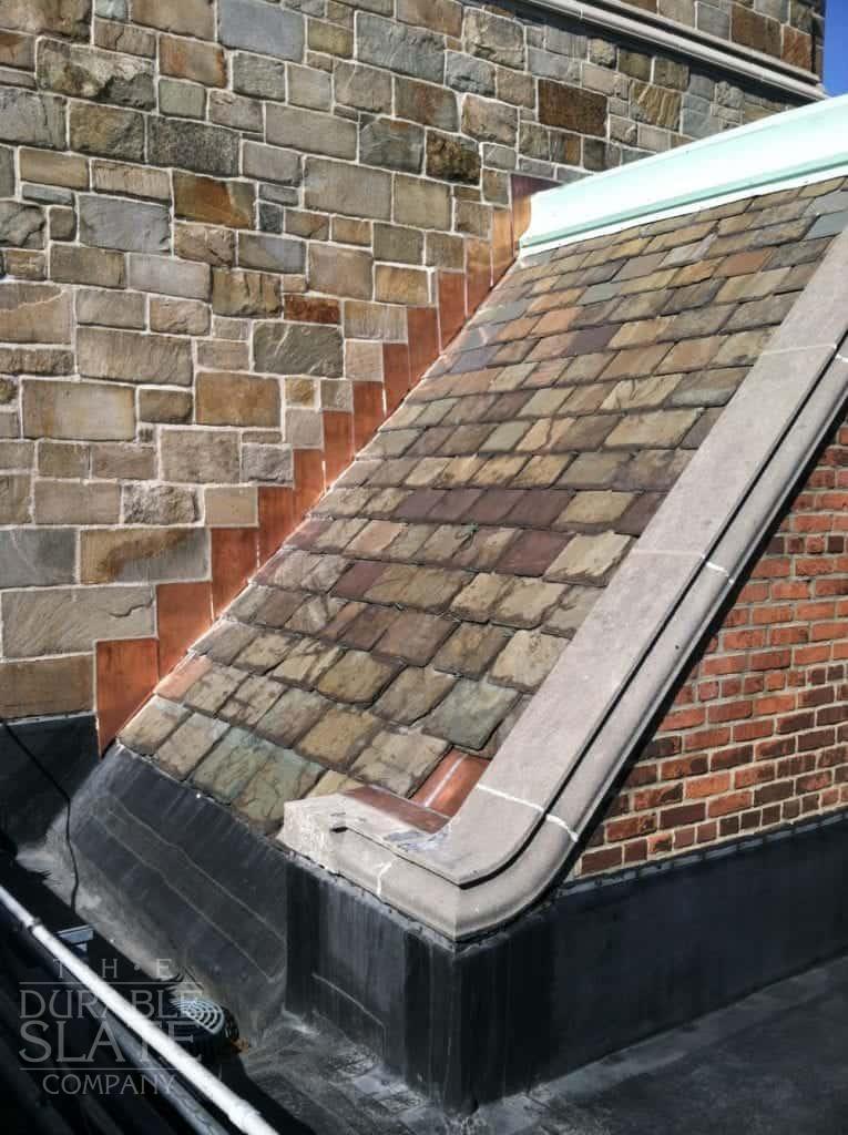 slate roof with copper flashing and cement border