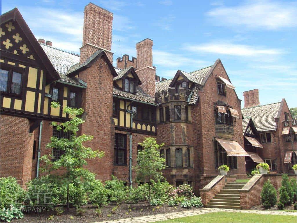 stan hywet hall in the spring with a blue sky behind the beautiful slate roof