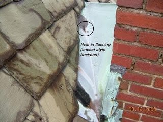 hole in flashing cricket causing leaky chimney