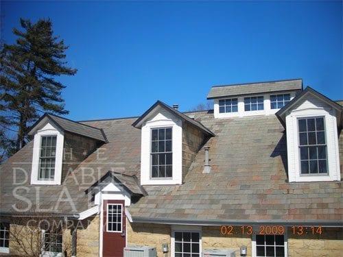 Extensive slate repair and replacement was performed throughout the roof. New custom fabricated copper flashings and gutters were installed.