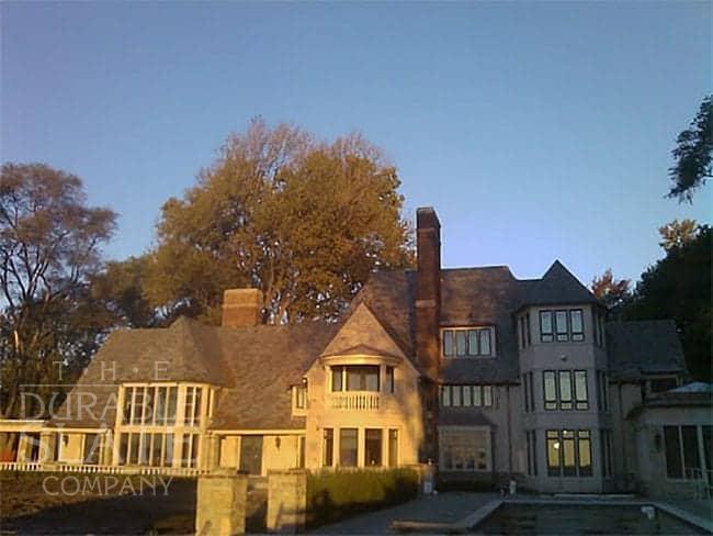 cotton residence from the back, with the sun setting highlighting the slate roof