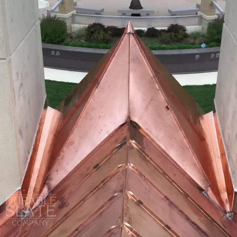 A copper panel pyramid atop a hurch roof