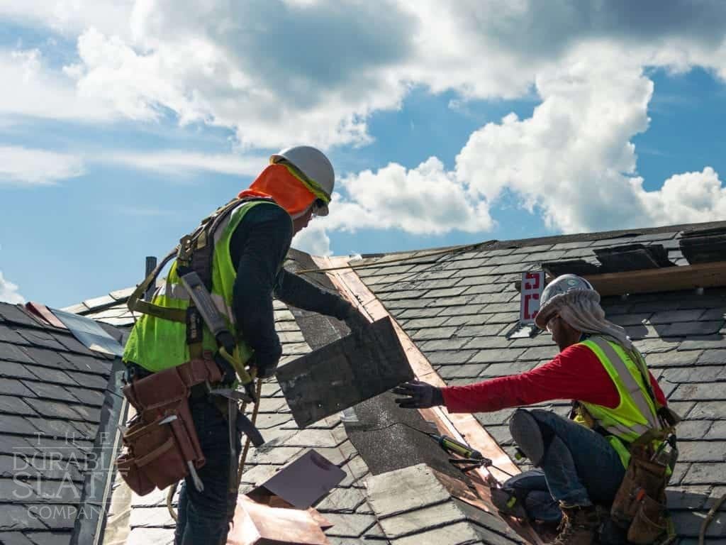 virginia tech building underneath a deep blue sky, slate roof repaired by two durable employees