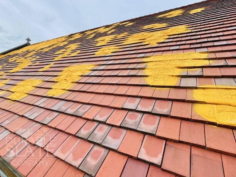 st. mary's catholic church in iowa clay roofing tile repair underway