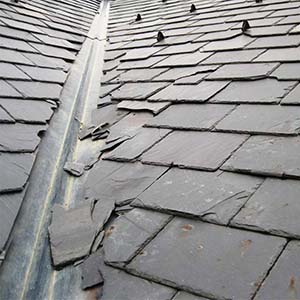 example of a bad slate roof installation that can resemble storm damage