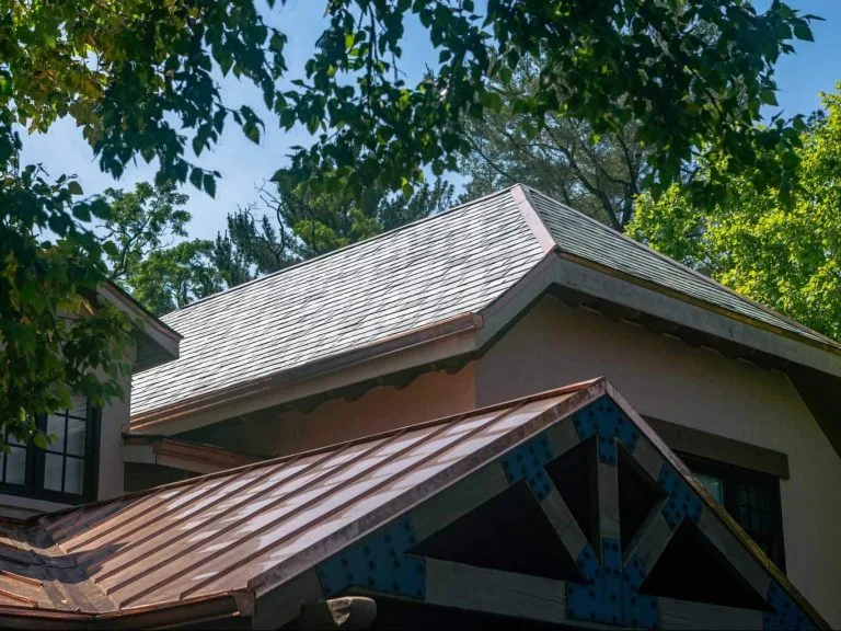 a new slate roof and a new copper roof on a residential building
