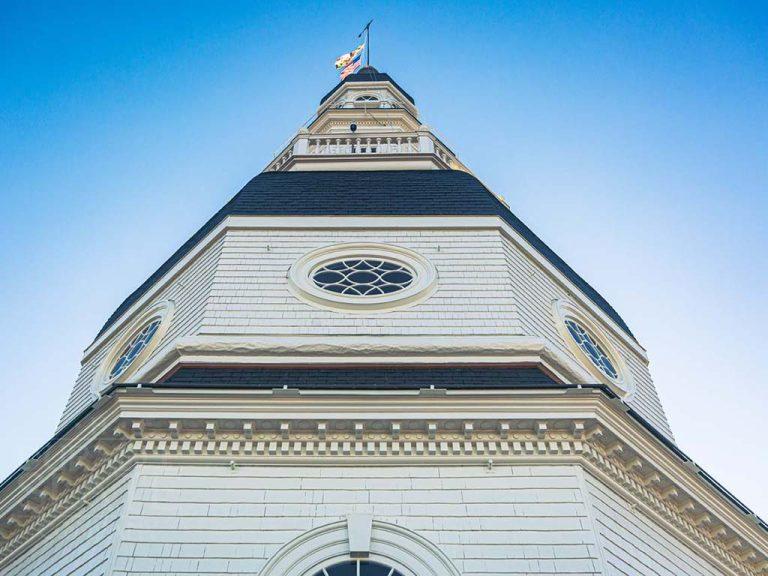 a large tall tower with a clock on the side of a building