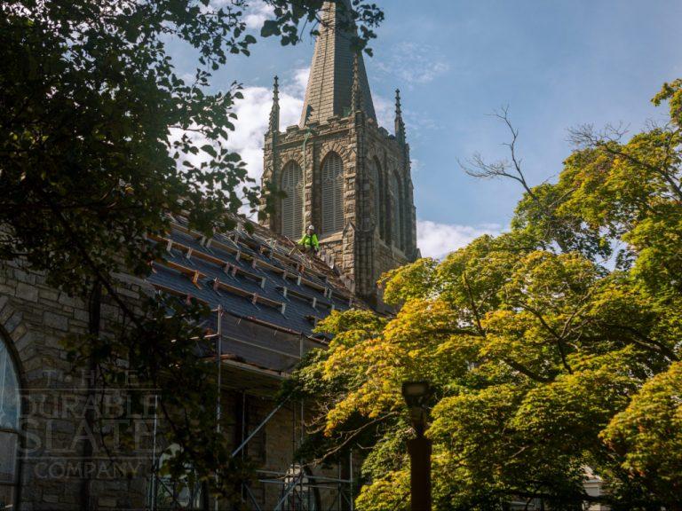 a large tall tower with a clock on the side of a building